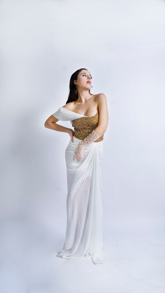 Gold encrusted bustier with ivory draped gown