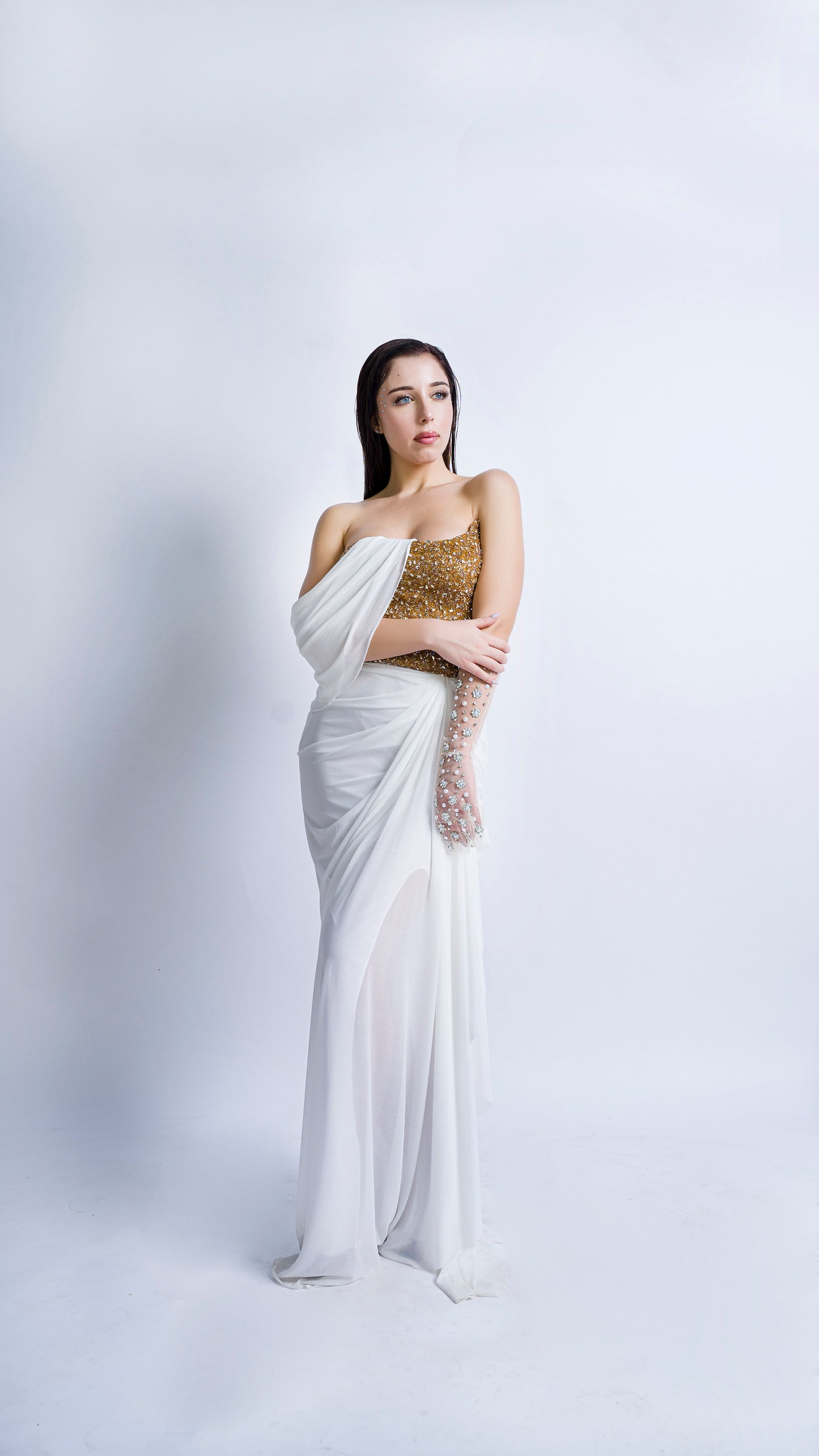 Gold encrusted bustier with ivory draped gown