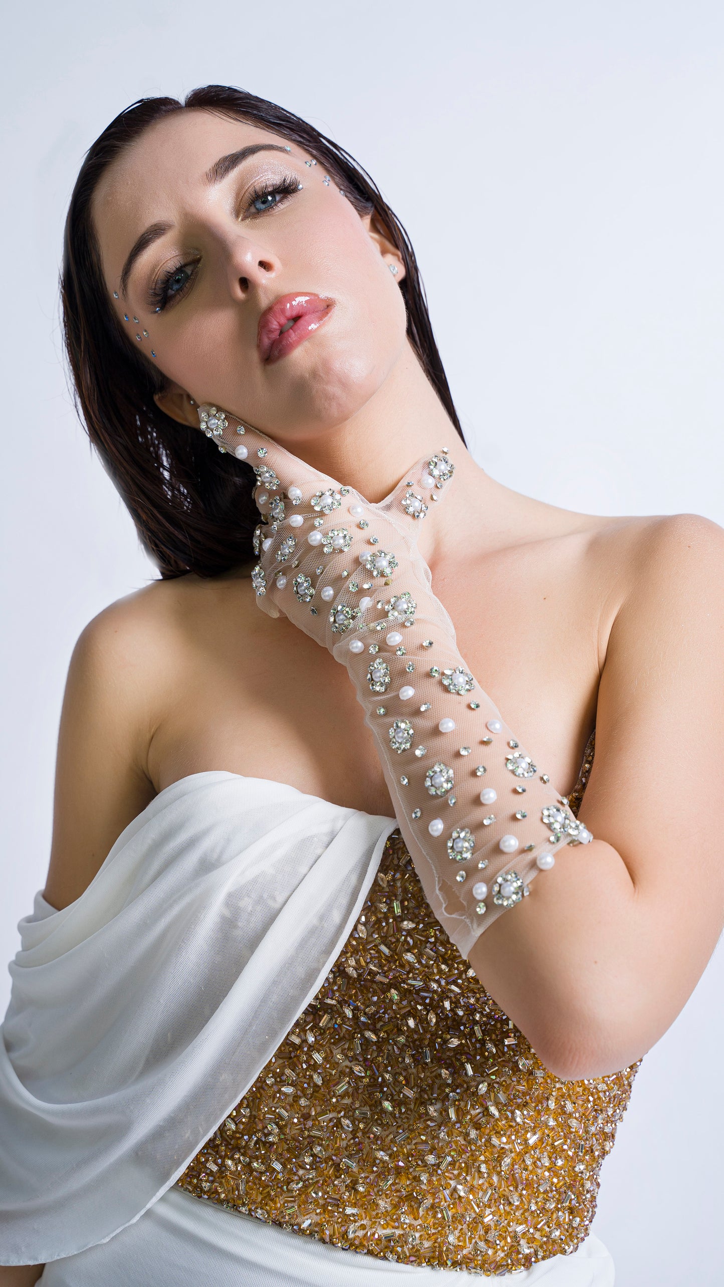Gold encrusted bustier with ivory draped gown