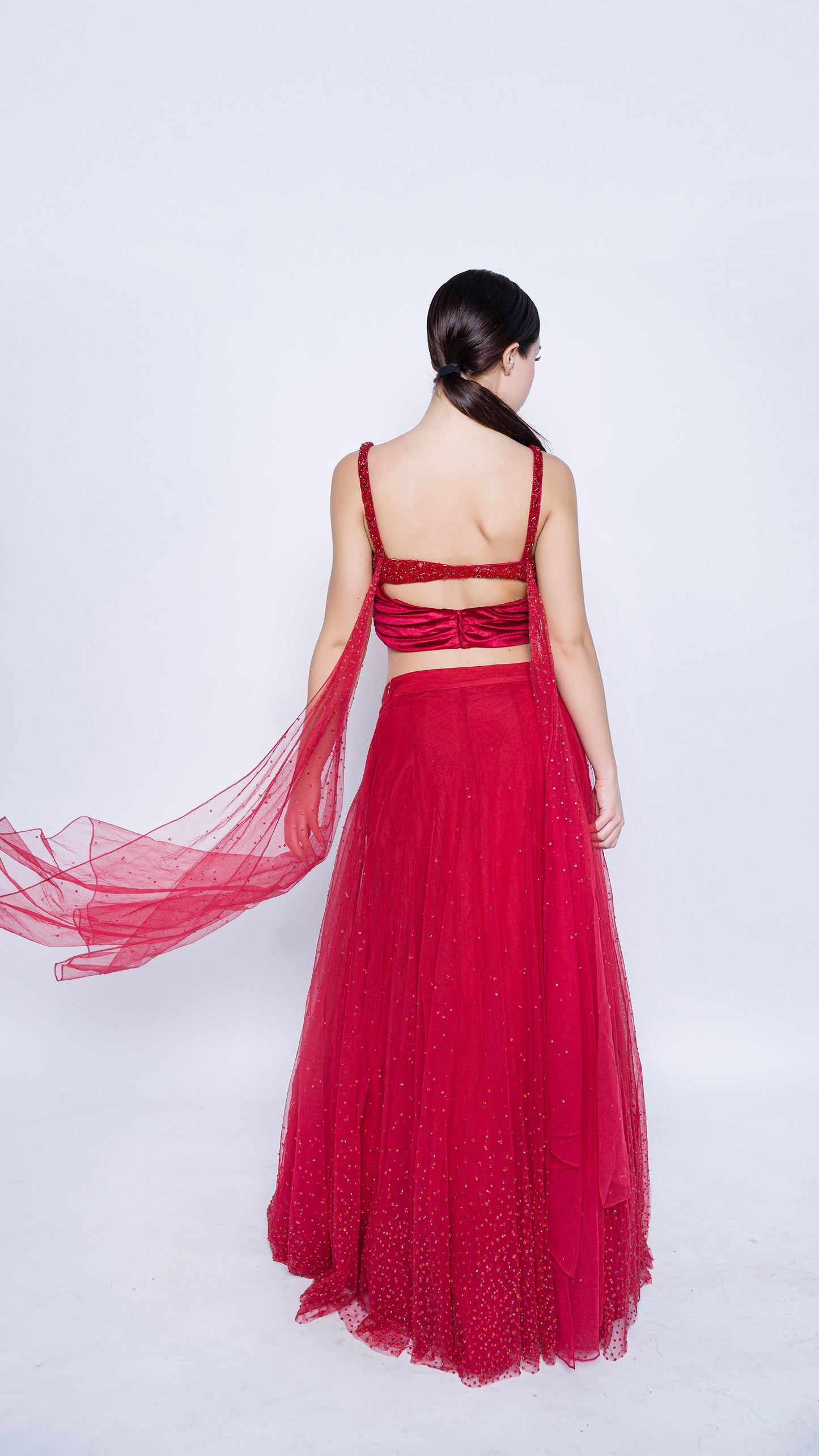 Red encrusted cowl drape blouse with crystal splatter lehenga set