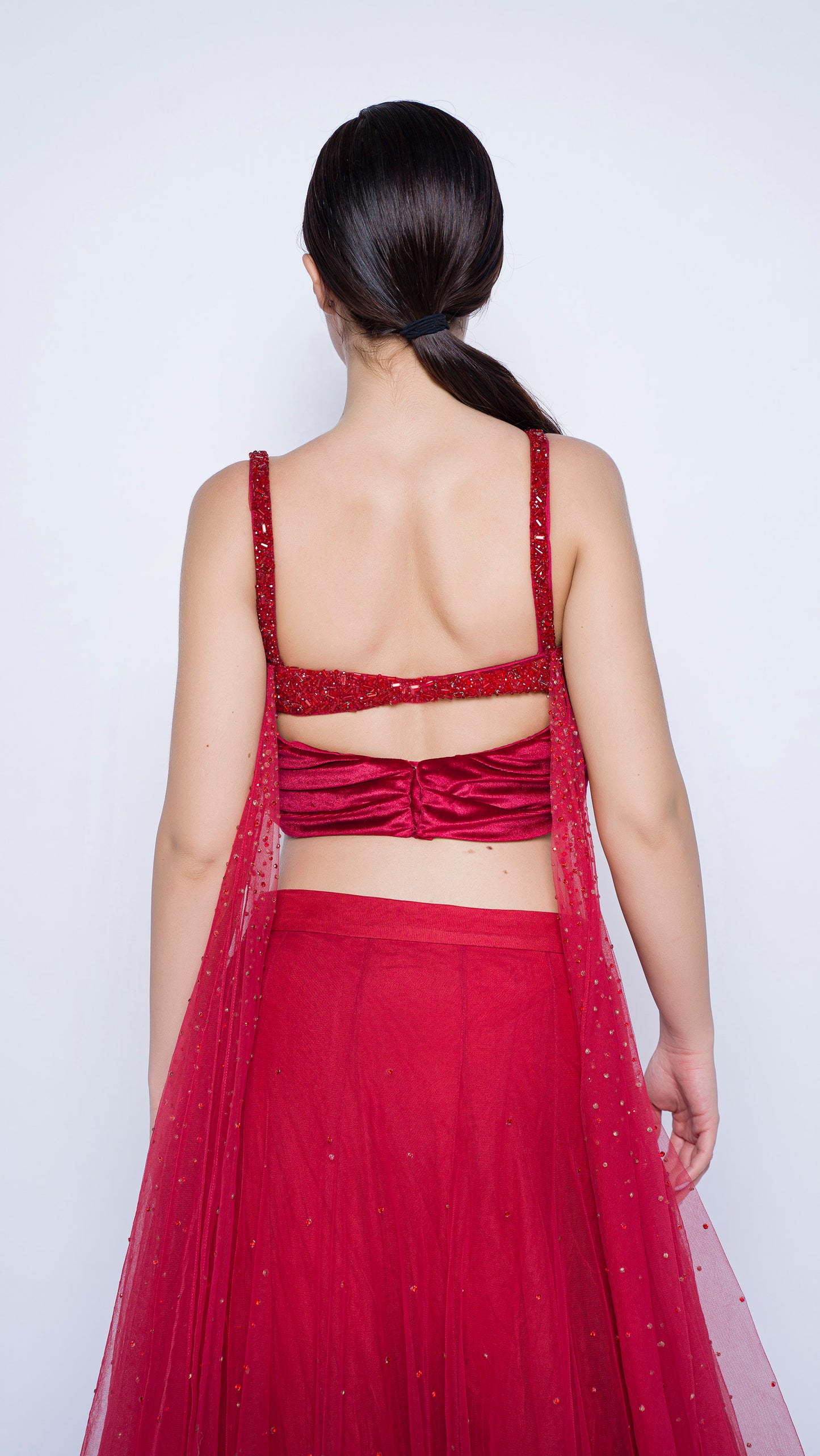 Red encrusted cowl drape blouse with crystal splatter lehenga set