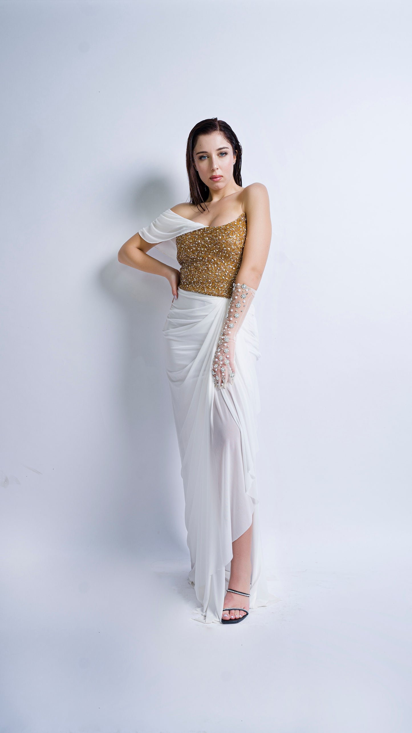 Gold encrusted bustier with ivory draped gown