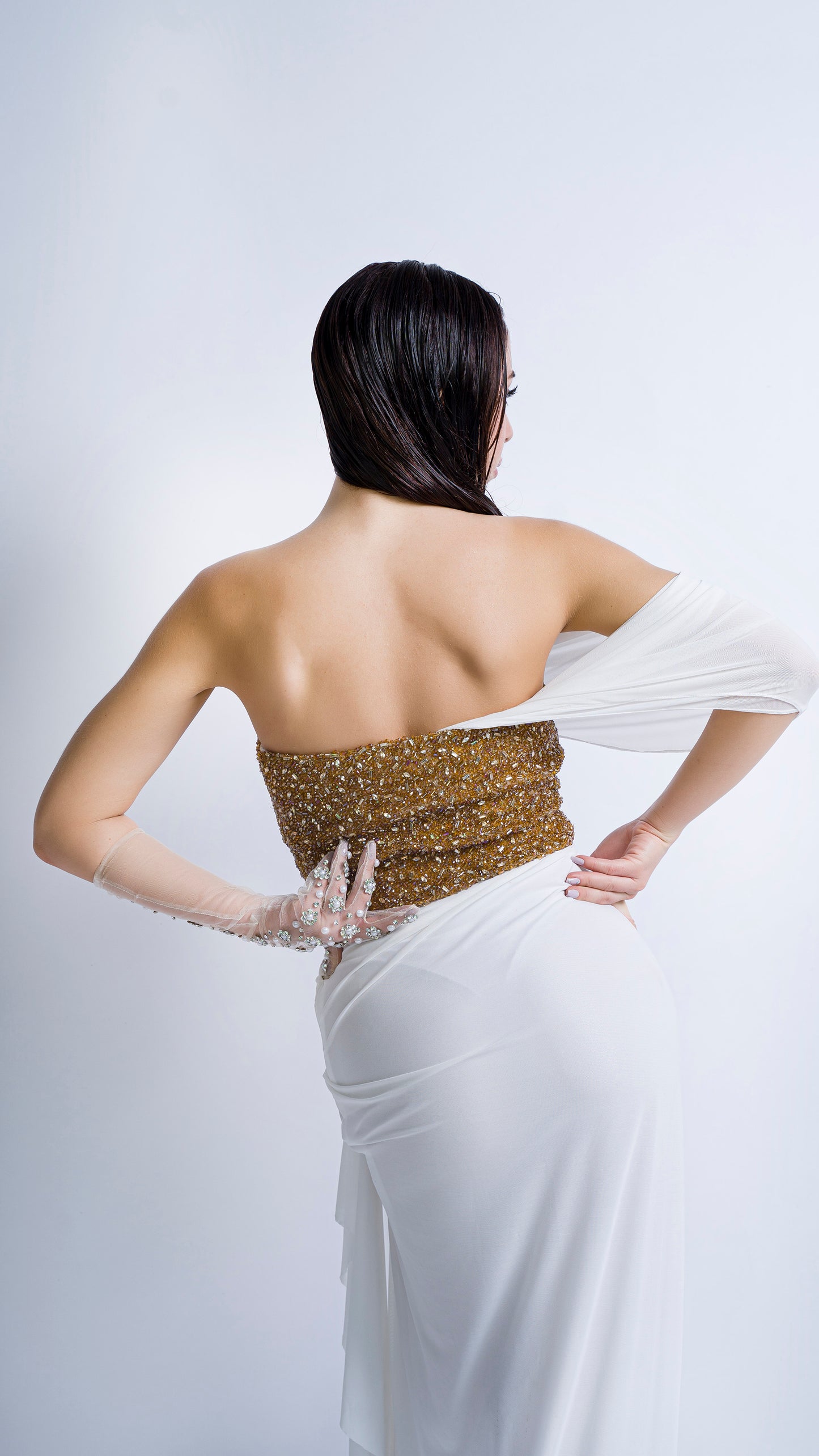 Gold encrusted bustier with ivory draped gown
